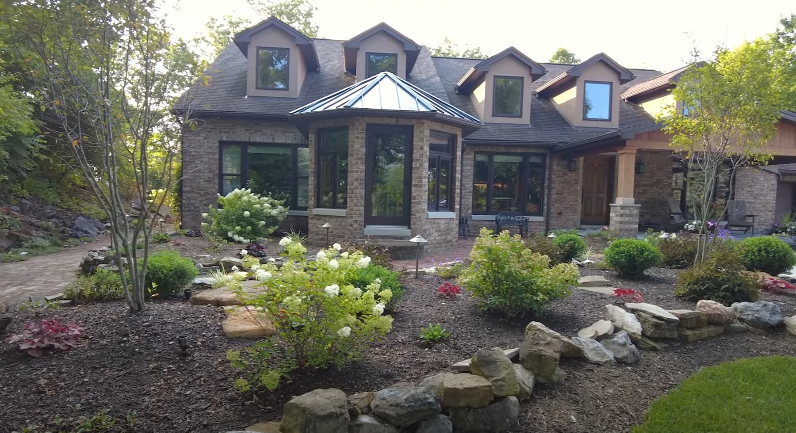 Modern Home Landscape Design Beautiful modern home with professional landscape design featuring hydrangeas, stone elements, and well-maintained garden beds